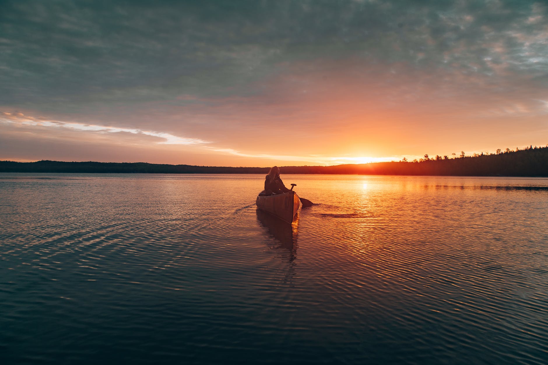 photo of person riding kayak