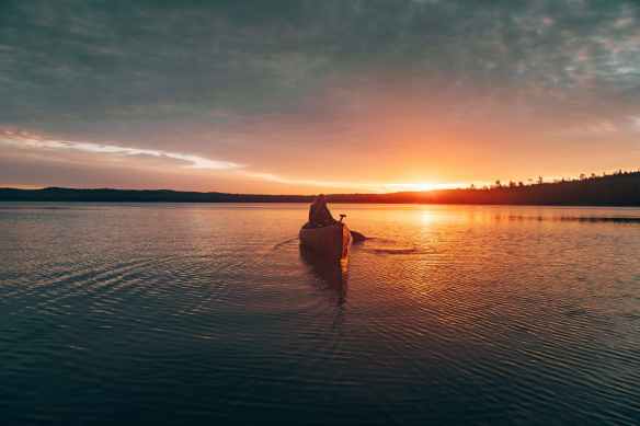 photo of person riding kayak
